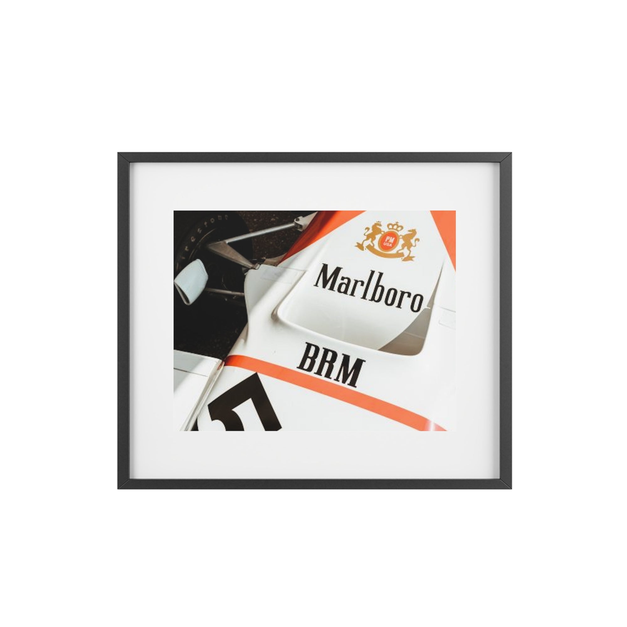 An old vintage formula one car close up of the classic Marlboro livery on the nose of the car with the suspension and tires showing.