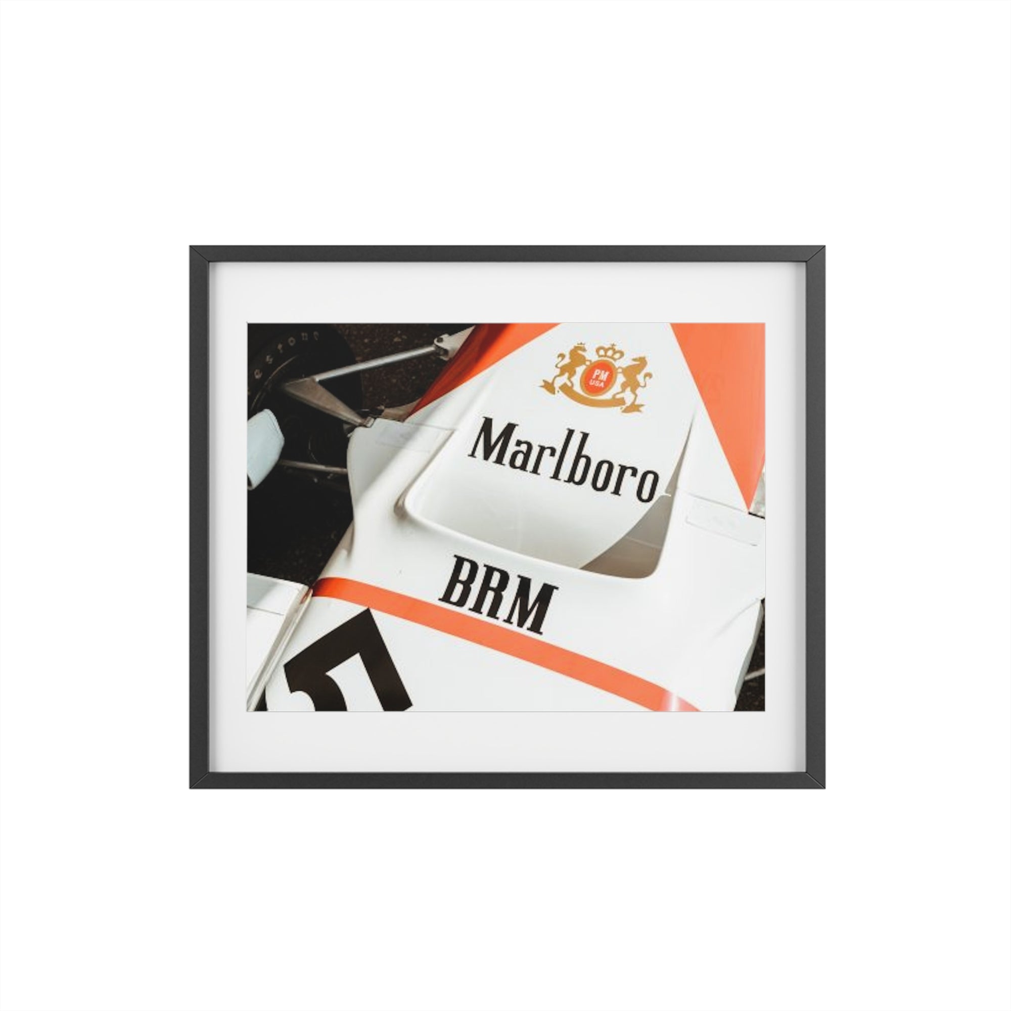 An old vintage formula one car close up of the classic Marlboro livery on the nose of the car with the suspension and tires showing.