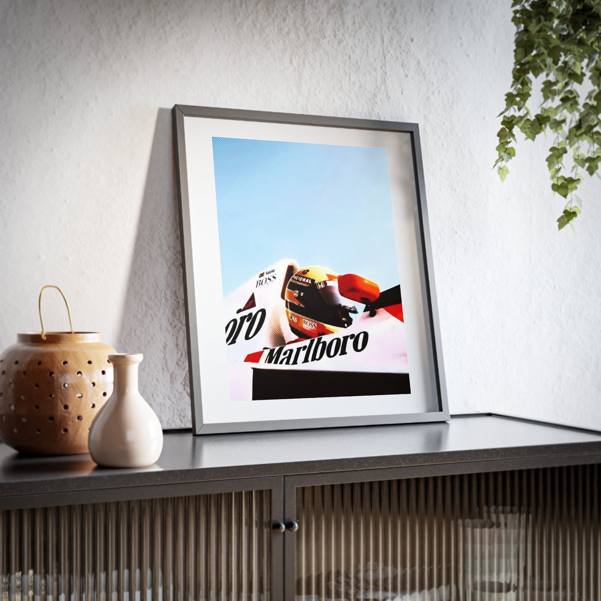 Bright and colorful framed Poster featuring Ayrton Senna in his Marlboro McLaren Formula One car.