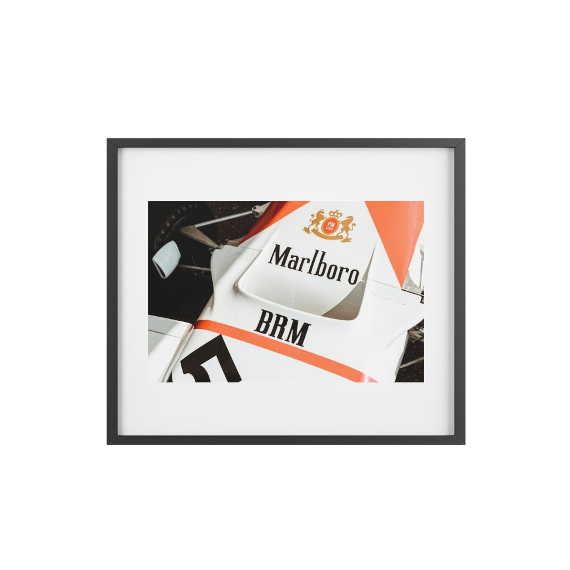 An old vintage formula one car close up of the classic Marlboro livery on the nose of the car with the suspension and tires showing.