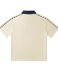 Beige polo shirt with navy trim on a white background
