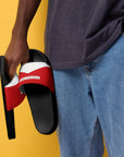 The Red's pool slides, red and white strap on black sole, held by model